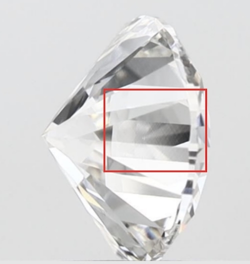 A side-view image of a lab-grown diamond with a red box highlighting striation within the carbon lattice. The visible hazy or banded structure suggests uneven growth, which can impact the diamond's brilliance and transparency.
